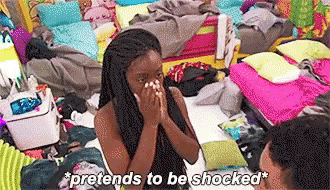 A Woman Is Sitting On A Bed With Her Hands On Her Face And The Words `` Pretends To Be Shocked '' Above Her . GIF