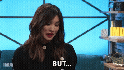 A Woman Is Sitting On A Blue Couch And Says But GIF