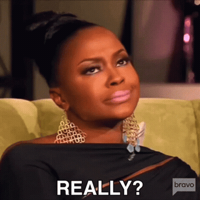 A Woman Is Sitting On A Couch And Making A Funny Face And The Words Really Are On The Bottom Of Her Face . GIF