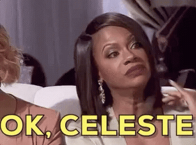 A Woman Is Sitting On A Couch And Making A Funny Face While Talking To Another Woman . GIF