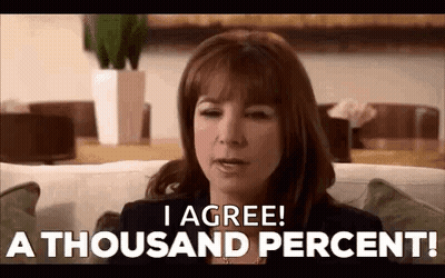 A Woman Is Sitting On A Couch And Saying `` I Agree ! A Thousand Percent '' . GIF