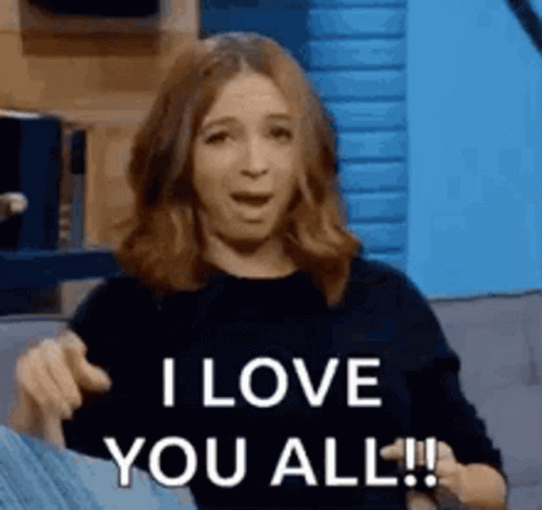 A Woman Is Sitting On A Couch And Saying `` I Love You All ! '' GIF