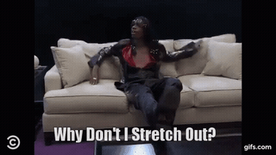 A Woman Is Sitting On A Couch And Saying Why Don 'T I Stretch Out GIF