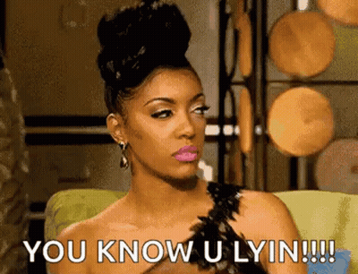 A Woman Is Sitting On A Couch And Saying `` You Know U Lyin !!! '' GIF