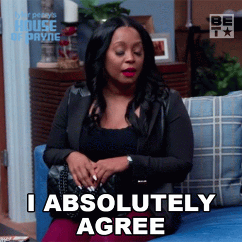 A Woman Is Sitting On A Couch And Says I Absolutely Agree GIF