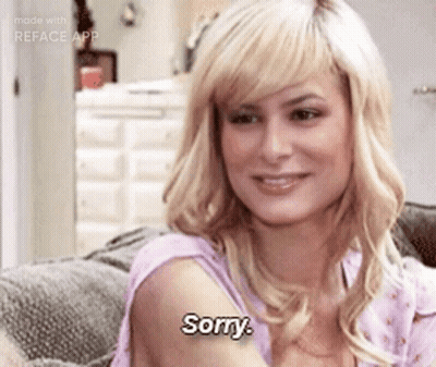 A Woman Is Sitting On A Couch And Says " Sorry " GIF