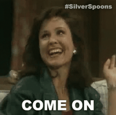 A Woman Is Sitting On A Couch And Smiling While Saying `` Come On '' . GIF
