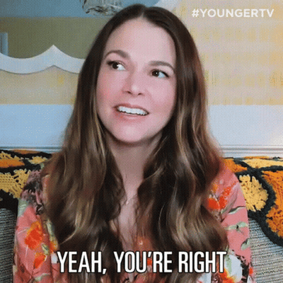 A Woman Is Sitting On A Couch And Smiling With The Words Yeah You 'Re Right Below Her GIF
