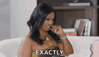 A Woman Is Sitting On A Couch Brushing Her Teeth With A Toothbrush . GIF