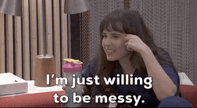 A Woman Is Sitting On A Couch Holding A Shaker And Saying I 'M Just Willing To Be Messy GIF