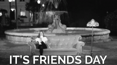 A Woman Is Sitting On A Couch In Front Of A Fountain With The Words `` It 'S Friends Day '' . GIF
