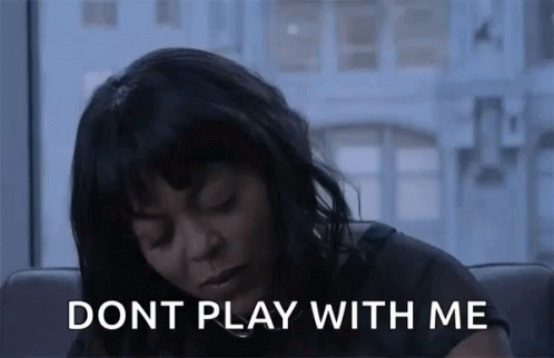 A Woman Is Sitting On A Couch In Front Of A Window And A Sign That Says `` Dont Play With Me '' . GIF
