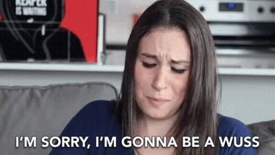 A Woman Is Sitting On A Couch Saying I 'M Sorry GIF