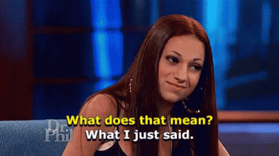 a woman is sitting on a couch talking about what does that mean .
