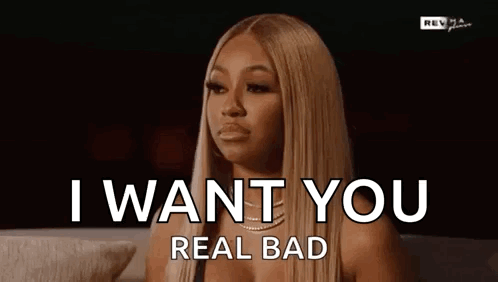 A Woman Is Sitting On A Couch With Her Eyes Closed And Says `` I Want You Real Bad '' . GIF