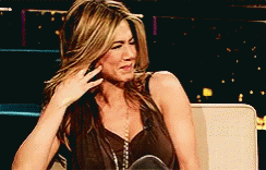 A Woman Is Sitting On A Couch With Her Hand On Her Face . GIF
