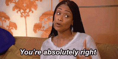 A Woman Is Sitting On A Couch With Her Hand Up And Says `` You 'Re Absolutely Right '' . GIF