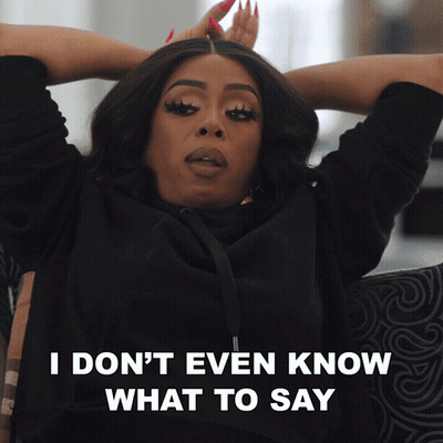 A Woman Is Sitting On A Couch With Her Hands Behind Her Head And The Words I Don 'T Even Know What To Say Below Her GIF