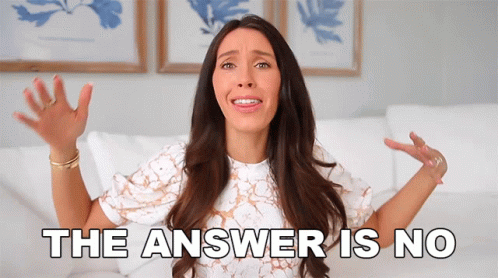 A Woman Is Sitting On A Couch With Her Hands In The Air And The Words The Answer Is No Behind Her GIF