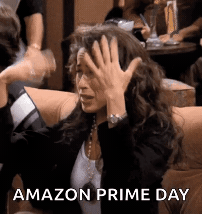 A Woman Is Sitting On A Couch With Her Hands On Her Head And The Words Amazon Prime Day Written On The Bottom GIF