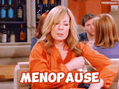 A Woman Is Sitting On A Couch With The Word Menopause Written On It GIF
