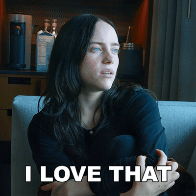 A Woman Is Sitting On A Couch With The Words " I Love That " Behind Her GIF
