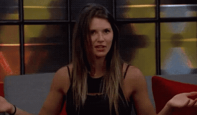 A Woman Is Sitting On A Couch With The Words You 'Re Delusional In Yellow Letters GIF