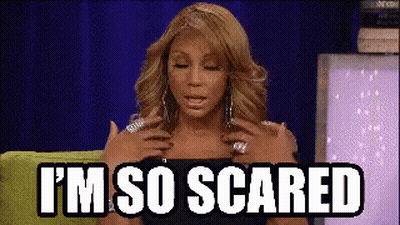 A Woman Is Sitting On A Green Couch With Her Hands On Her Chest And The Words `` I 'M So Scared '' . GIF