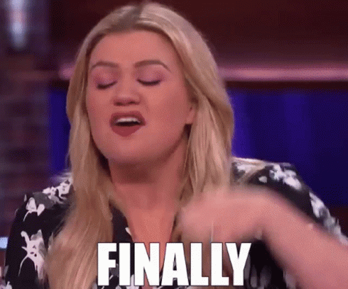A Woman Is Sitting On A Stage With Her Eyes Closed And Says Finally . GIF