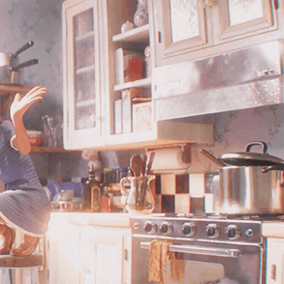 A Woman Is Sitting On A Stool In A Kitchen With A Pot On The Stove GIF