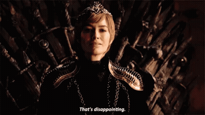 A Woman Is Sitting On A Throne With A Crown On Her Head And Smiling . GIF