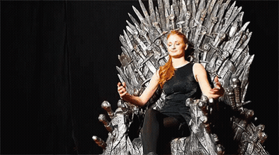 A Woman Is Sitting On A Throne With Her Eyes Closed And Holding A Sword . GIF