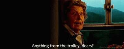 A Woman Is Sitting On A Train And Says Anything From The Trolley Dears . GIF