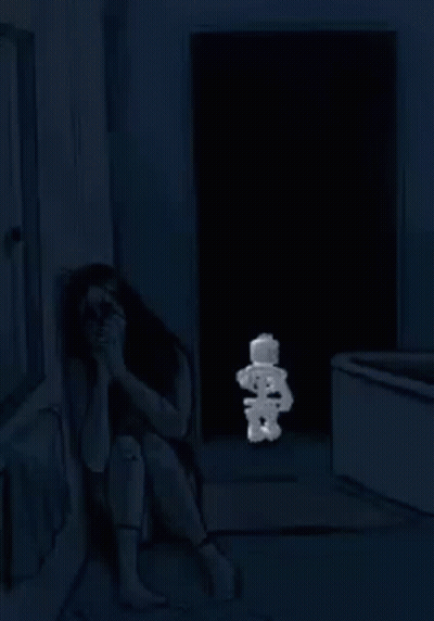 A Woman Is Sitting On The Floor In A Dark Room With A Stuffed Smurf . GIF