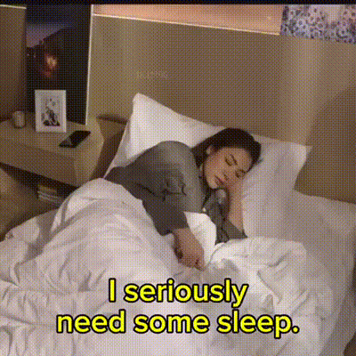 A Woman Is Sleeping In A Bed With The Words " I Seriously Need Some Sleep " Below Her GIF
