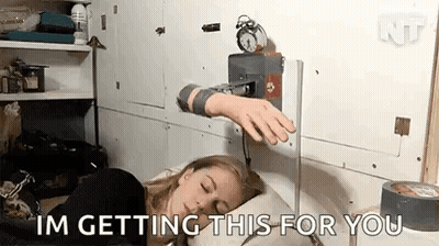 A Woman Is Sleeping In Bed With An Alarm Clock On The Wall Behind Her . GIF