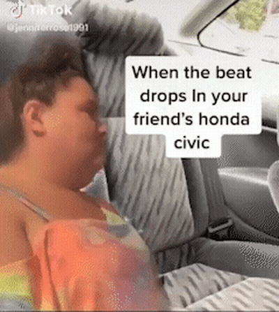 A Woman Is Sleeping In The Back Seat Of A Honda Civic GIF