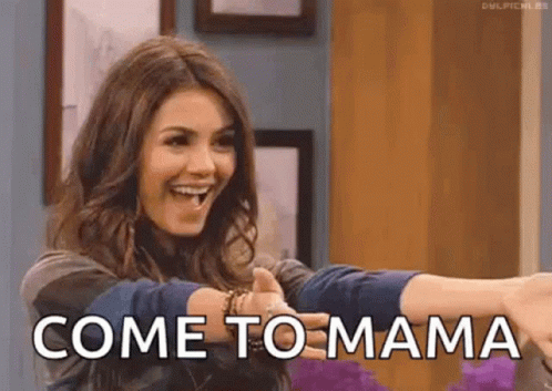 A Woman Is Smiling And Giving A Thumbs Up And The Words Come To Mama Are Visible Behind Her . GIF