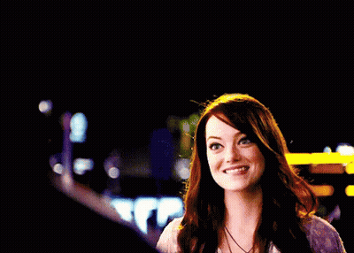 A Woman Is Smiling And Giving A Thumbs Up Sign GIF