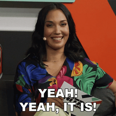 A Woman Is Smiling And Holding A Piece Of Paper That Says Yeah It Is GIF