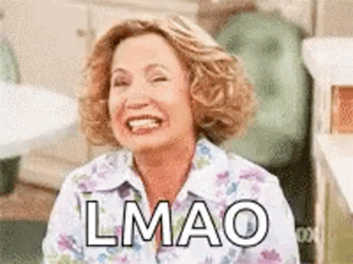 A Woman Is Smiling And Laughing With The Words `` Lmao '' Written On Her Face . GIF