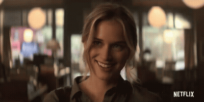 A Woman Is Smiling And Looking At The Camera In A Blurry Photo From Netflix . GIF