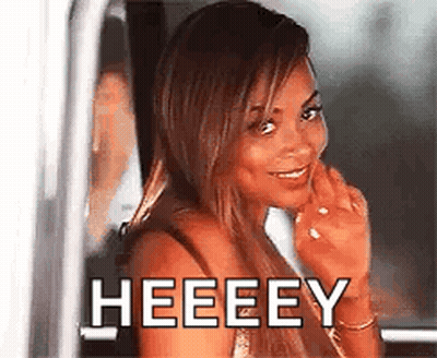 A Woman Is Smiling And Looking Out Of A Car Window With The Words Heeeey Written On It . GIF