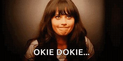 A Woman Is Smiling And Making A Face With The Words `` Okie Dokie '' Written On The Bottom Of Her Face . GIF