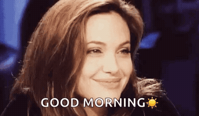A Woman Is Smiling And Saying `` Good Morning '' With A Sun In The Background . GIF