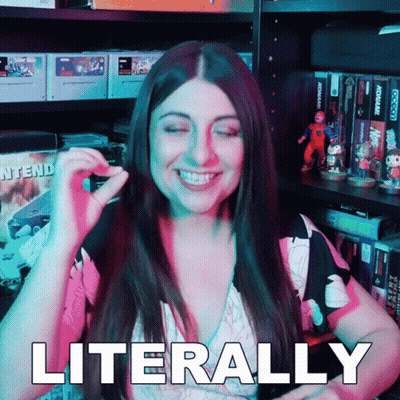 A Woman Is Smiling And Says Literally In Front Of A Video Game Shelf GIF