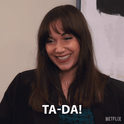 A Woman Is Smiling And Says Ta-Da In A Netflix Ad GIF
