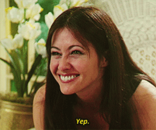 A Woman Is Smiling And Says Yep In Yellow GIF