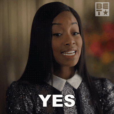 A Woman Is Smiling And Says Yes In Front Of Her Face GIF