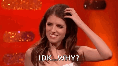 A Woman Is Smiling And Scratching Her Head With Her Hand . GIF